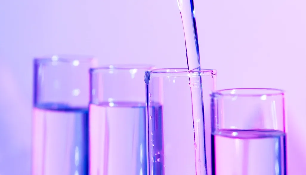 Liquid poured between laboratory test tubes